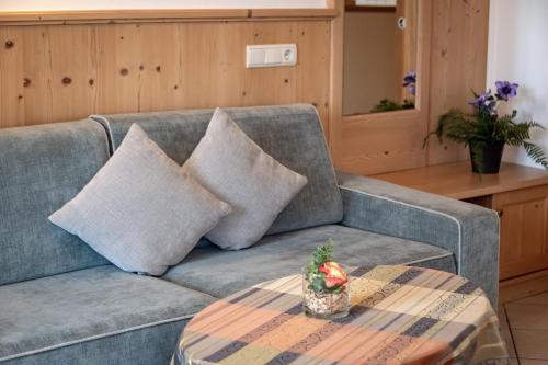 a living room with a couch and a table at Residence Diana Apartment 301 in Terento