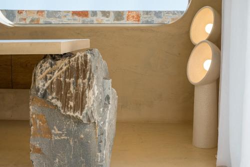 a room with a rock and two lights at Sunshine Boutique Hotel by Estia in Malia