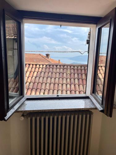 a window with a view of a roof at I Tre Fratelli in Vignone