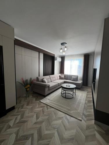 a living room with a couch and a table at Erlaiden Apartment in Shkodër