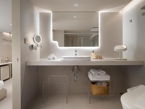 a bathroom with a sink and a mirror at Lore Hotel in Taipei