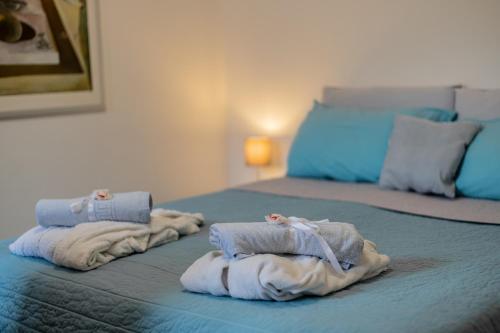 a room with two beds with towels on them at Fogazzaro Lake View Apartment in Oria