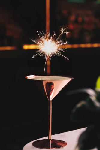 a sparkler in a martini glass on a table at JA Palm Tree Court, Dubai in Dubai