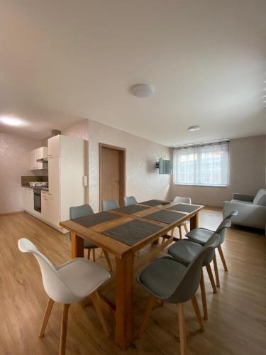 a dining table and chairs in a living room at Marianna Apartments Weimer in Rust