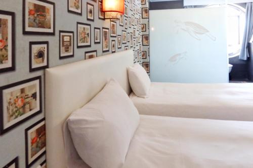 Postel nebo postele na pokoji v ubytování Love River Inn 愛河日央