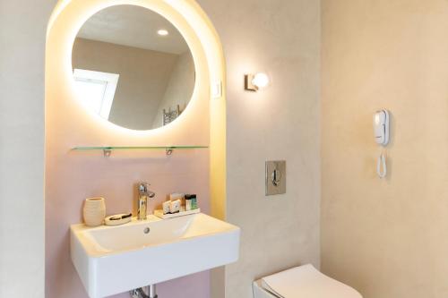 a bathroom with a sink and a mirror at St. George Hotel in Sofia