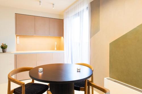 a kitchen and dining room with a table and chairs at St. George Hotel in Sofia
