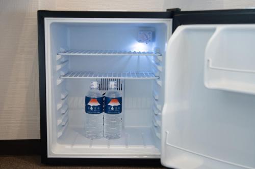 two bottles of water are inside of an open refrigerator at Hotel Arashiyama in Kyoto