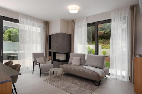 a living room with a couch and a fireplace at The Q Whisper - new deluxe hideaway with sauna, jacuzzi and a garage in Rovinj