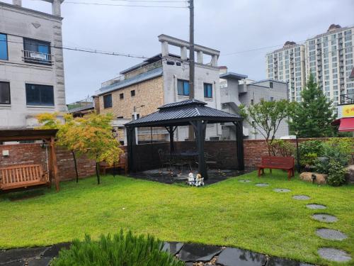 a garden with a gazebo in a yard at Moon Drawing Goeun in Chuncheon