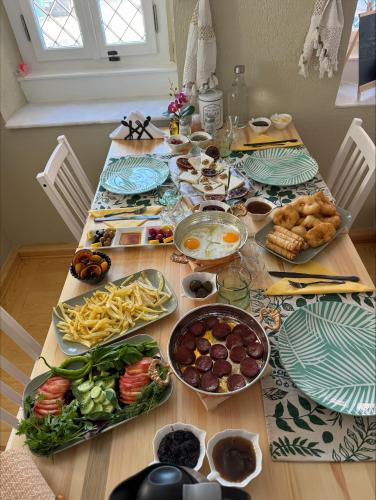 a table with plates of food on top of it at Cunda Bebekli Pansiyon in Ayvalık