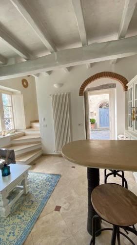 a living room with a table and chairs and a staircase at - La Casa di Rosi- Versilia & Free Parking- in Camaiore