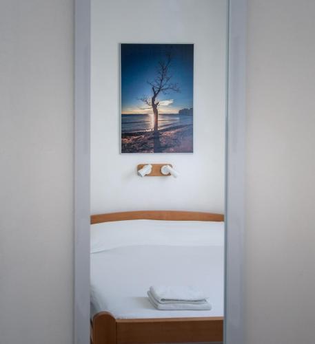 a bedroom with a bed with a picture on the wall at Kornati Paradise Residence Slanica in Murter