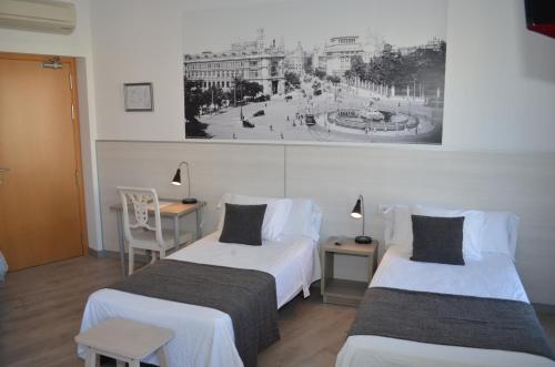 Postel nebo postele na pokoji v ubytování Hostal San Lorenzo