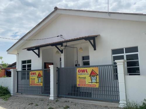 a white house with eviction signs in front of it at Nana OWL Homestay A & B Roomstay C & D in Kemasik