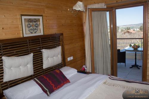 a bedroom with a bed and a balcony at Dar Zaghouan in Zaghouan