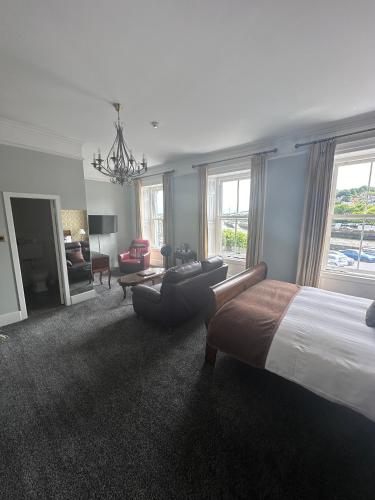 a large bedroom with a bed and a living room at Long Quay House in Kinsale