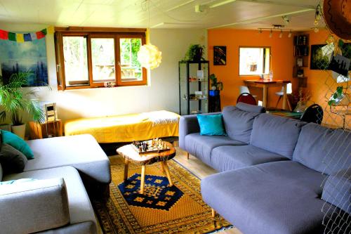 a living room with blue couches and a table at Nisihof, Abendblick in Oberkirch