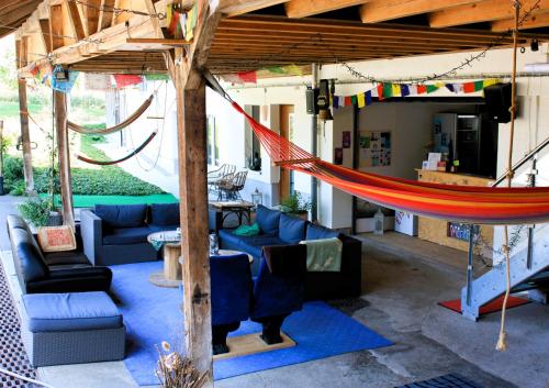 a hammock in a room with couches and chairs at Nisihof, Abendblick in Oberkirch