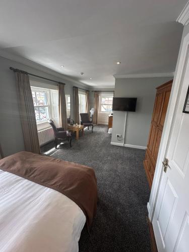 a hotel room with a bed and a tv at Long Quay House in Kinsale
