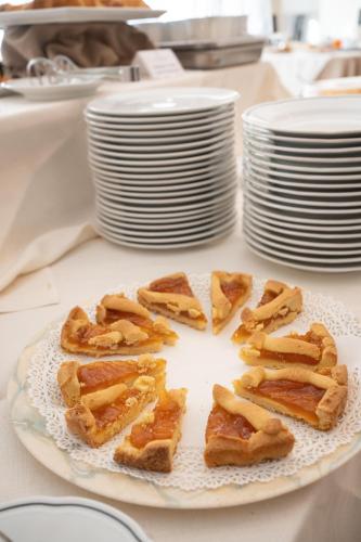 a plate of food with waffles on a table at Hotel San Pancrazio in Trescore Balneario