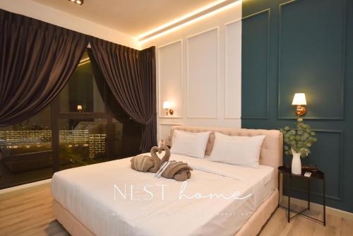 a bedroom with a bed with a nest home sign on it at Midvalley Southkey Mosaic Suite by Nest Home in Johor Bahru