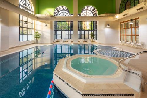 a large indoor pool with a large swimming pool at Crowne Plaza Leeds by IHG in Leeds