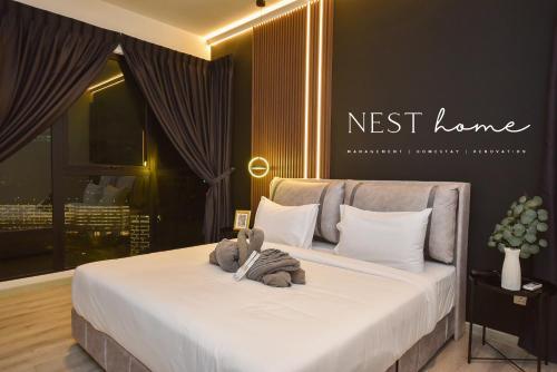 a bedroom with a bed with two teddy bears on it at Midvalley Southkey Mosaic Suite by Nest Home in Johor Bahru
