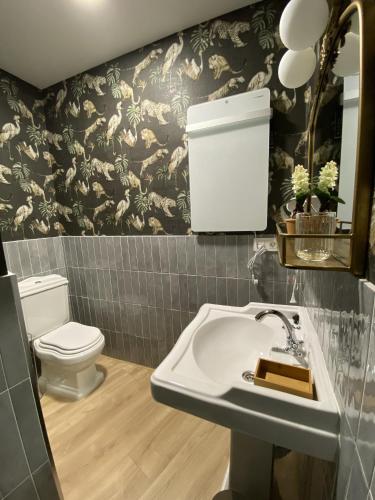 a bathroom with a toilet and a sink at Apartamentos Peñalara in Segovia