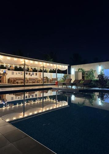 a house with a pool at night with lights at Fukuchani Inn Hotel in Kigongoni