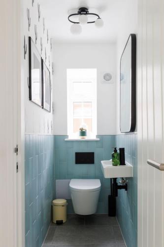 a bathroom with a toilet and a sink at Coastal Retreat for 10 with Hot Tub in West Wittering