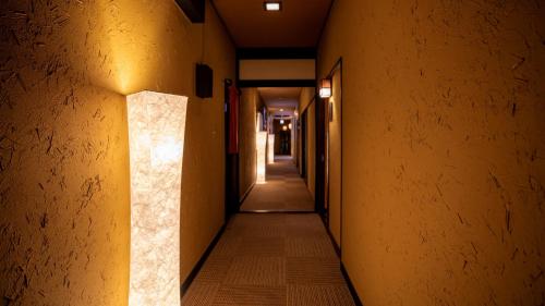 a corridor of an alley with yellow walls at Omoideno Jinde in Izu