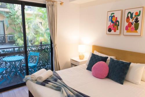 a bedroom with a bed with a large window at Charming One-Bedroom Apartment in Northbridge in Perth