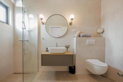 a bathroom with a sink and a mirror at Luxury Villa Oliva Oliana heated pool 32m2 in Vrsi