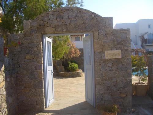 an entrance to a stone building with an open door at Pleiades Modern Villa with Shared Pool in Ornos in Ornos