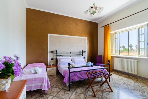 a bedroom with two beds and a window at Casa Venere Luxury Apartment in Giuggianello