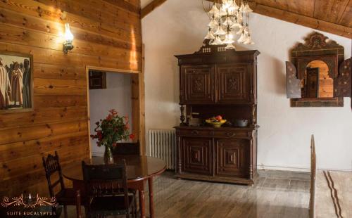 a dining room with a table and a large wooden cabinet at Dar Zaghouan in Zaghouan
