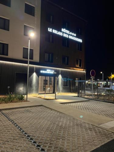 a building with a street light in front of it at Hôtel Le Relais des Brasseurs - Aubagne in Aubagne