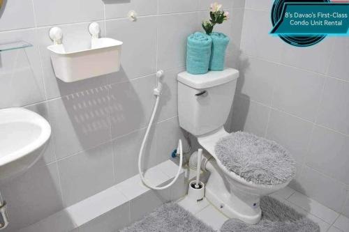 a bathroom with a toilet and a sink at 8's Davao's First-Class Condo Unit in Davao City