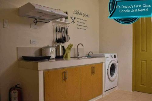 a kitchen with a sink and a washing machine at 8's Davao's First-Class Condo Unit in Davao City