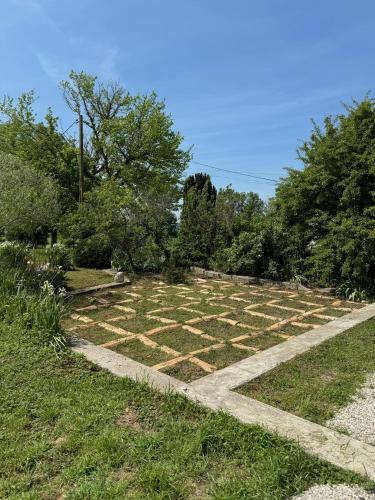 a garden with a stone path in the grass at Le Clos des 4 Bastides in Saint-Eutrope-de-Born