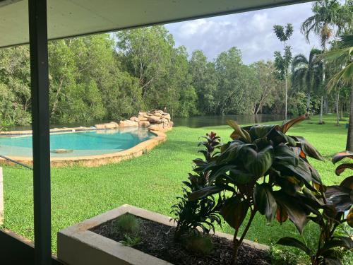 a view of a swimming pool from a window at Riverside Homestead in Southport
