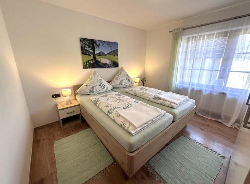 a small bedroom with a bed and a window at Ferienwohnung Heidi mit Oberstaufen PLUS in Oberstaufen
