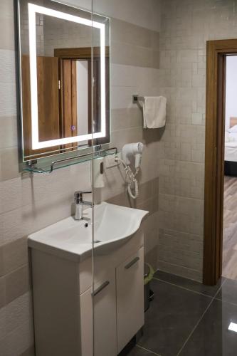 a bathroom with a white sink and a mirror at Ragusa Villa in Stolac