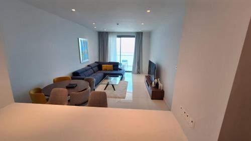 a living room with a couch and a table at Del Mar 2 Bedroom Deluxe Seaside 'A' Residence in Limassol