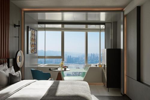 a bedroom with a bed and a view of a bathroom at ISEYA Panoramic Hotel Chongqing Jiefangbei Raffles Plaza in Chongqing