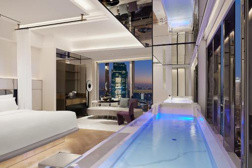 a bedroom with a pool in the middle of a hotel room at ISEYA Panoramic Hotel Chongqing Jiefangbei Raffles Plaza in Chongqing