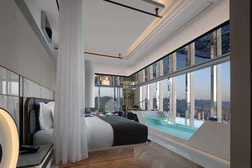 a bedroom with a king sized bed and large windows at ISEYA Panoramic Hotel Chongqing Jiefangbei Raffles Plaza in Chongqing