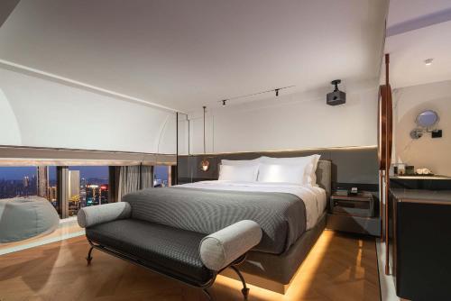 a bedroom with a large bed and a large window at ISEYA Panoramic Hotel Chongqing Jiefangbei Raffles Plaza in Chongqing