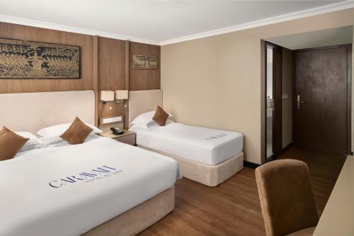 Una cama o camas en una habitación de Caravan Hotel by EHM